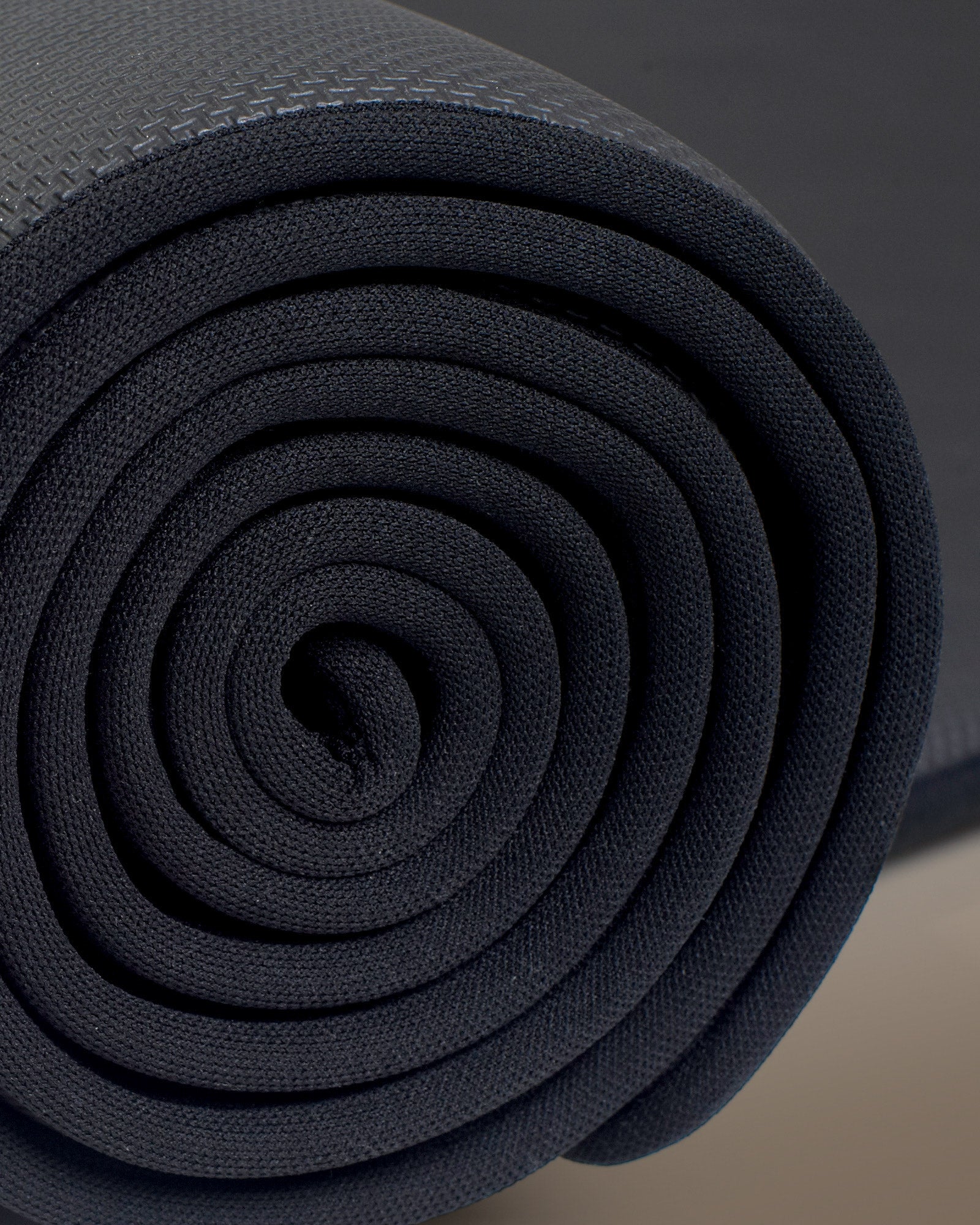 Close-up of the rolled edge of a Bliss mat, showing its stacked layers